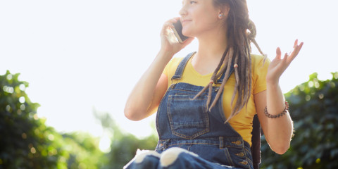 jonge vrouw met beperking in rolstoel met smartphone 1